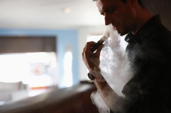 Enthusiast Damien Hoops uses an electronic cigarette at The Vapor Spot vapor bar in Los Angeles
